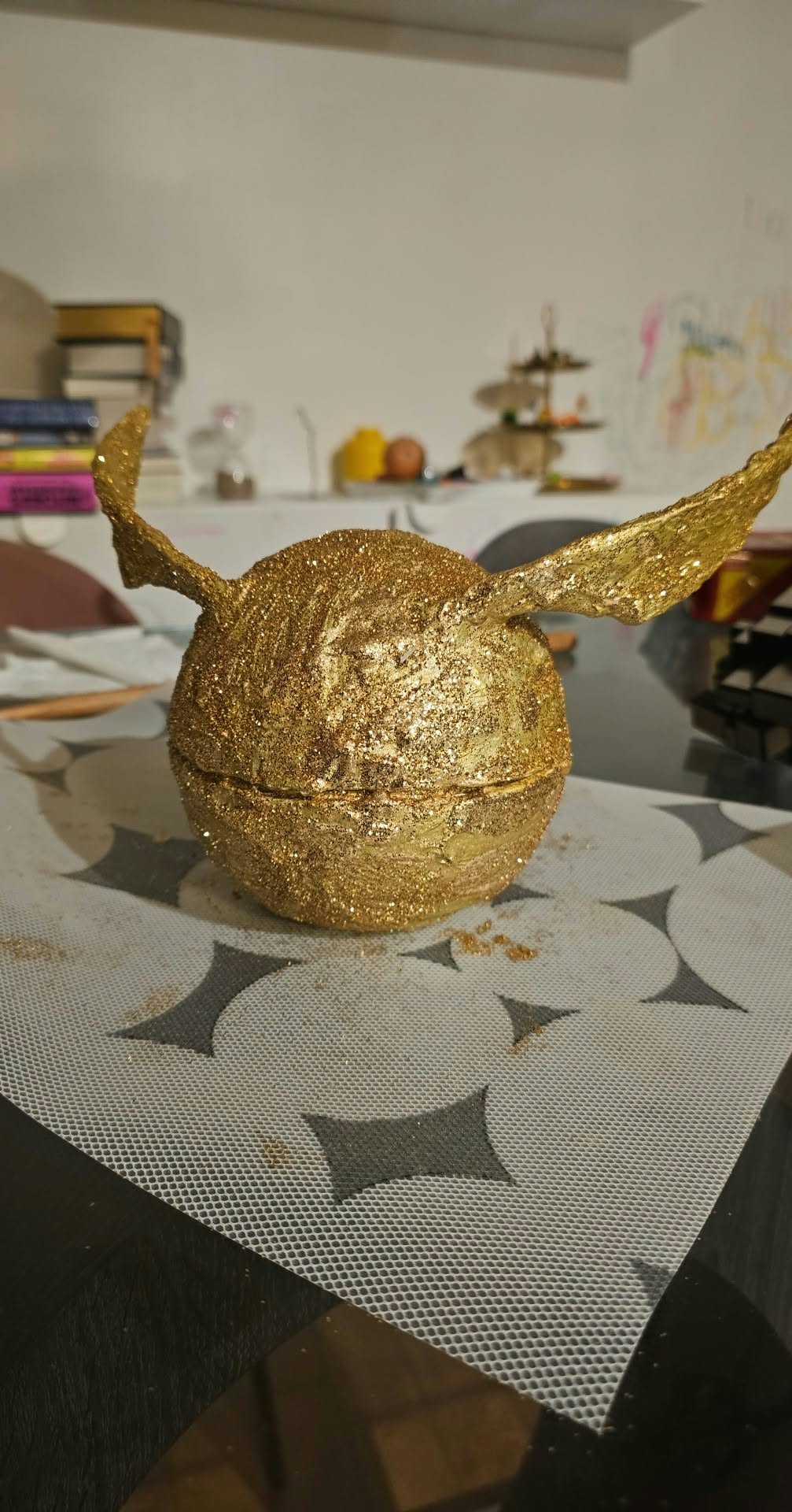 The revamped Golden Snitch holder with textured gold paint, glitter, and raised wings.