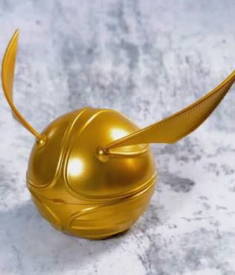 The original Tim Hortons Golden Snitch Timbits Holder, a smooth gold plastic ball with two wings.